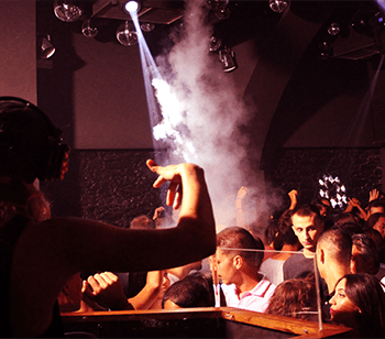 DJ performing to a packed dancefloor